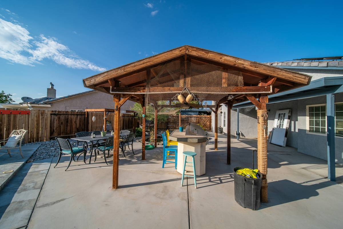 Smart curtain lights outdoor 20x10ft installed on a wooden pergola with ambient LED glow at dusk