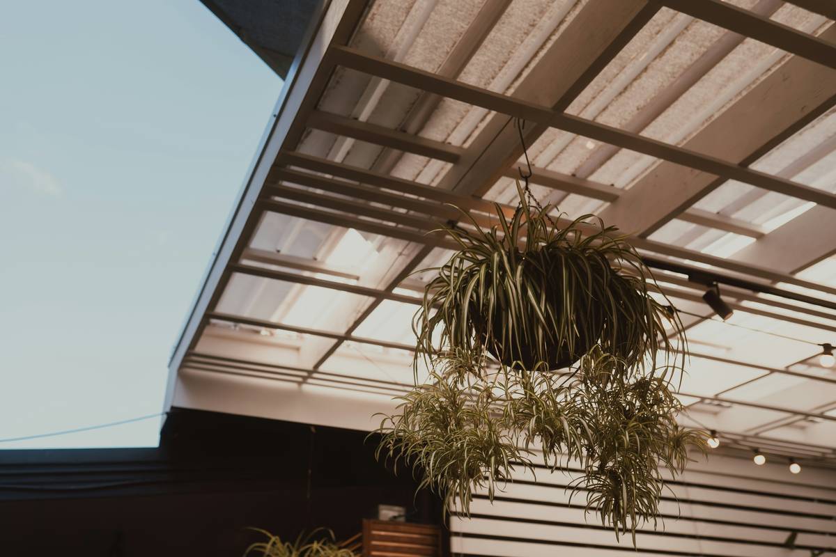window treatment smart curtain how to showing a smart curtain rail mounted beside a patio door with an outdoor rattan sofa visible through the glass