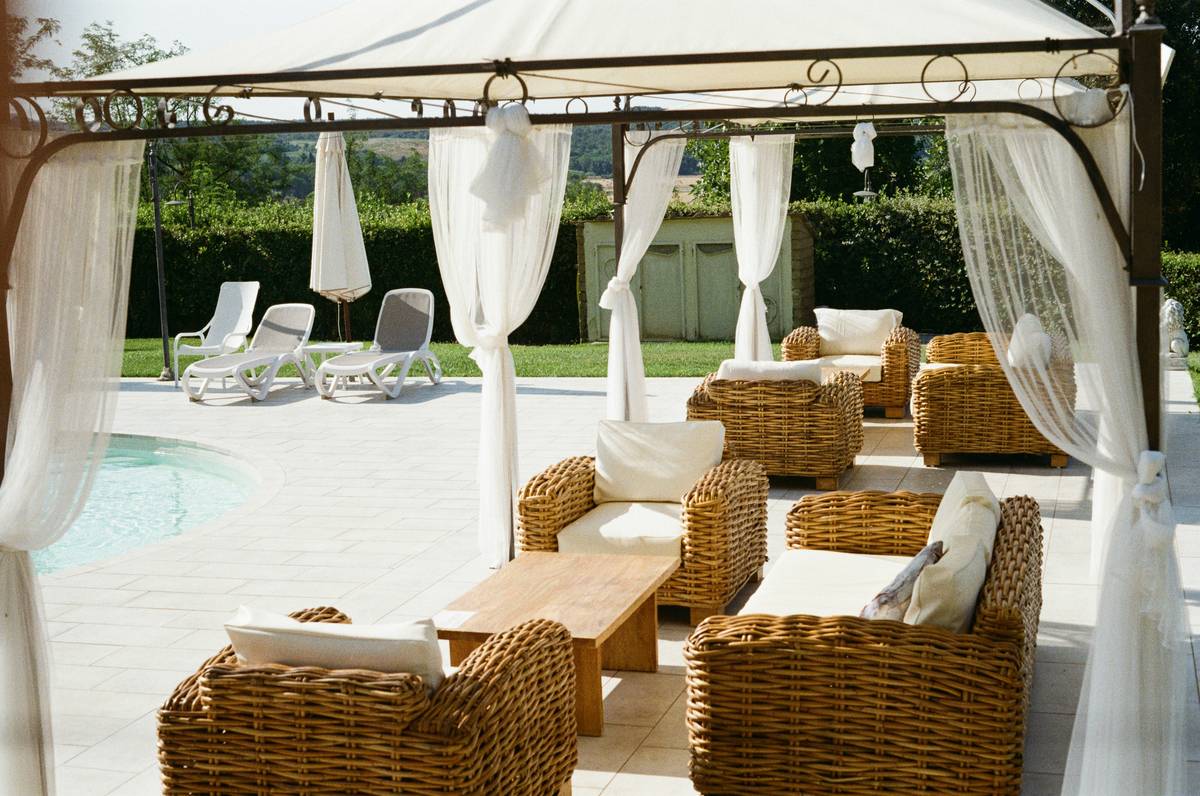 Outdoor curtains home depot installation on a modern pergola with aluminum track, remote control visible on ledge
